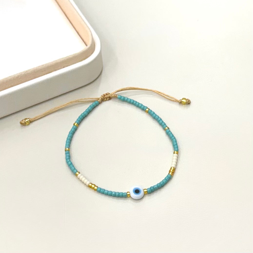 PULSERA TURQUESA Y CREMA | OJITO | LUNAM